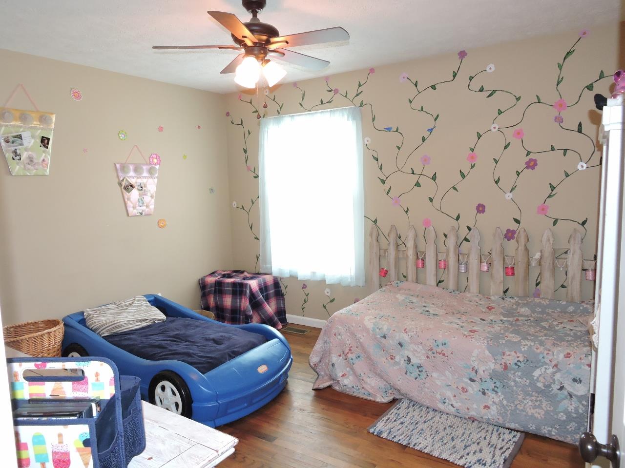 259 Bell Road Morrison, TN 37357 - Photo 16 of 27 a bedroom with a bed and a chandelier