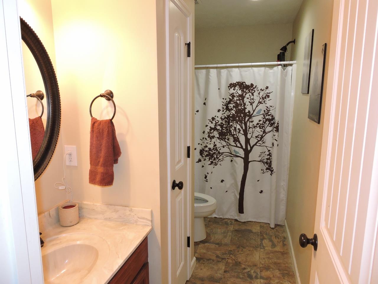 259 Bell Road Morrison, TN 37357 - Photo 18 of 27 a bathroom with a granite countertop sink toilet and shower
