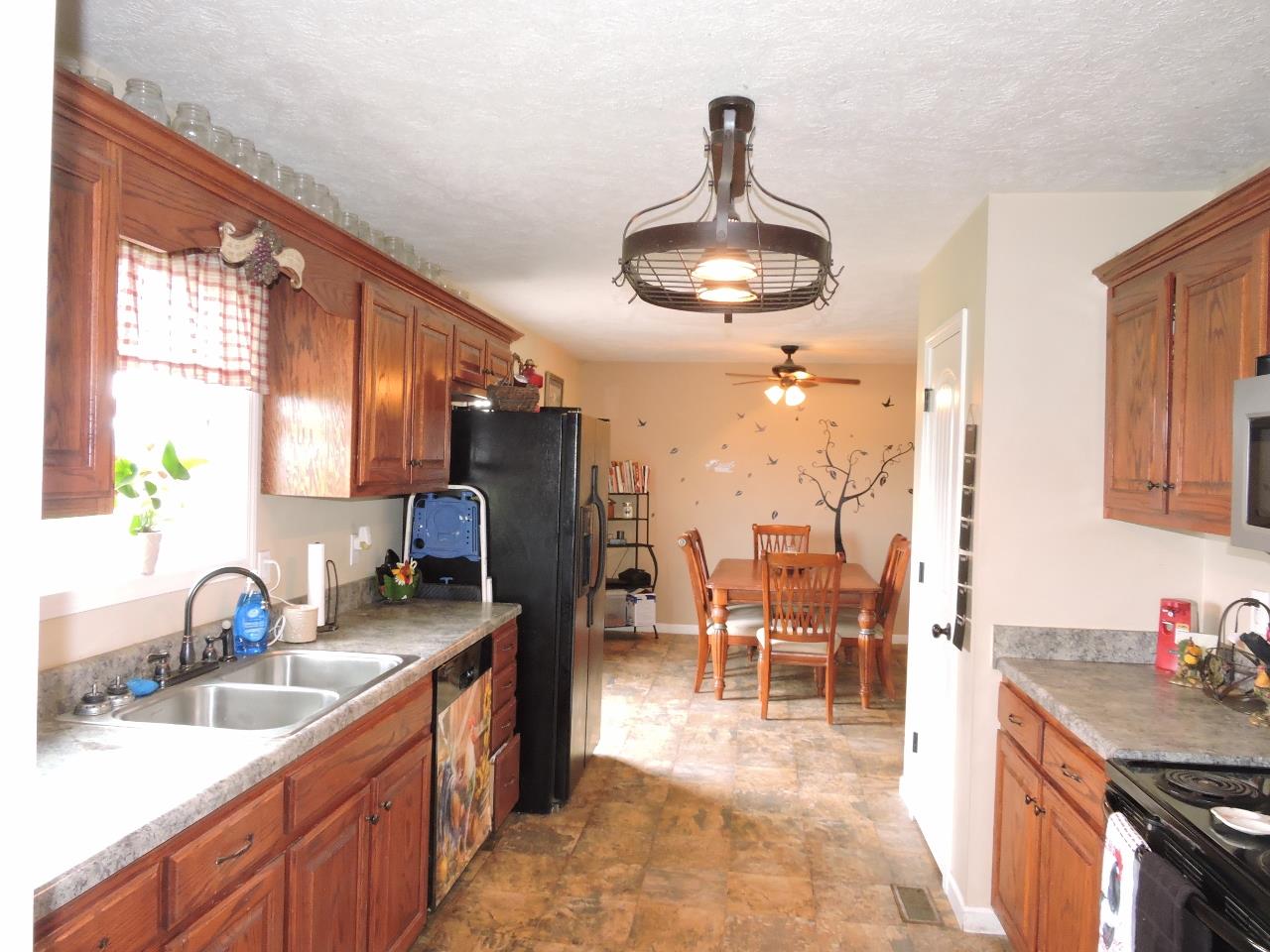 259 Bell Road Morrison, TN 37357 - Photo 8 of 27 a kitchen with stainless steel appliances granite countertop a sink and a stove