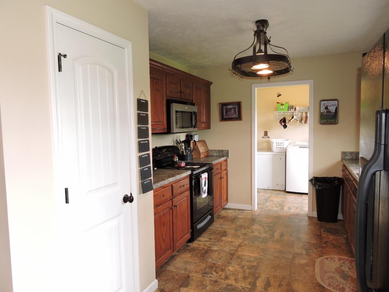 259 Bell Road Morrison, TN 37357 - Photo 9 of 27 a kitchen with stainless steel appliances granite countertop a sink and a refrigerator