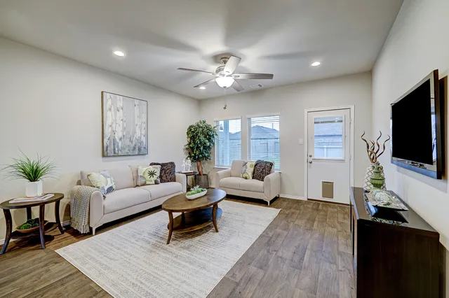 a living room with furniture and a flat screen tv