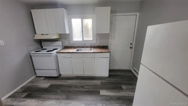a kitchen with a stove a refrigerator and a sink