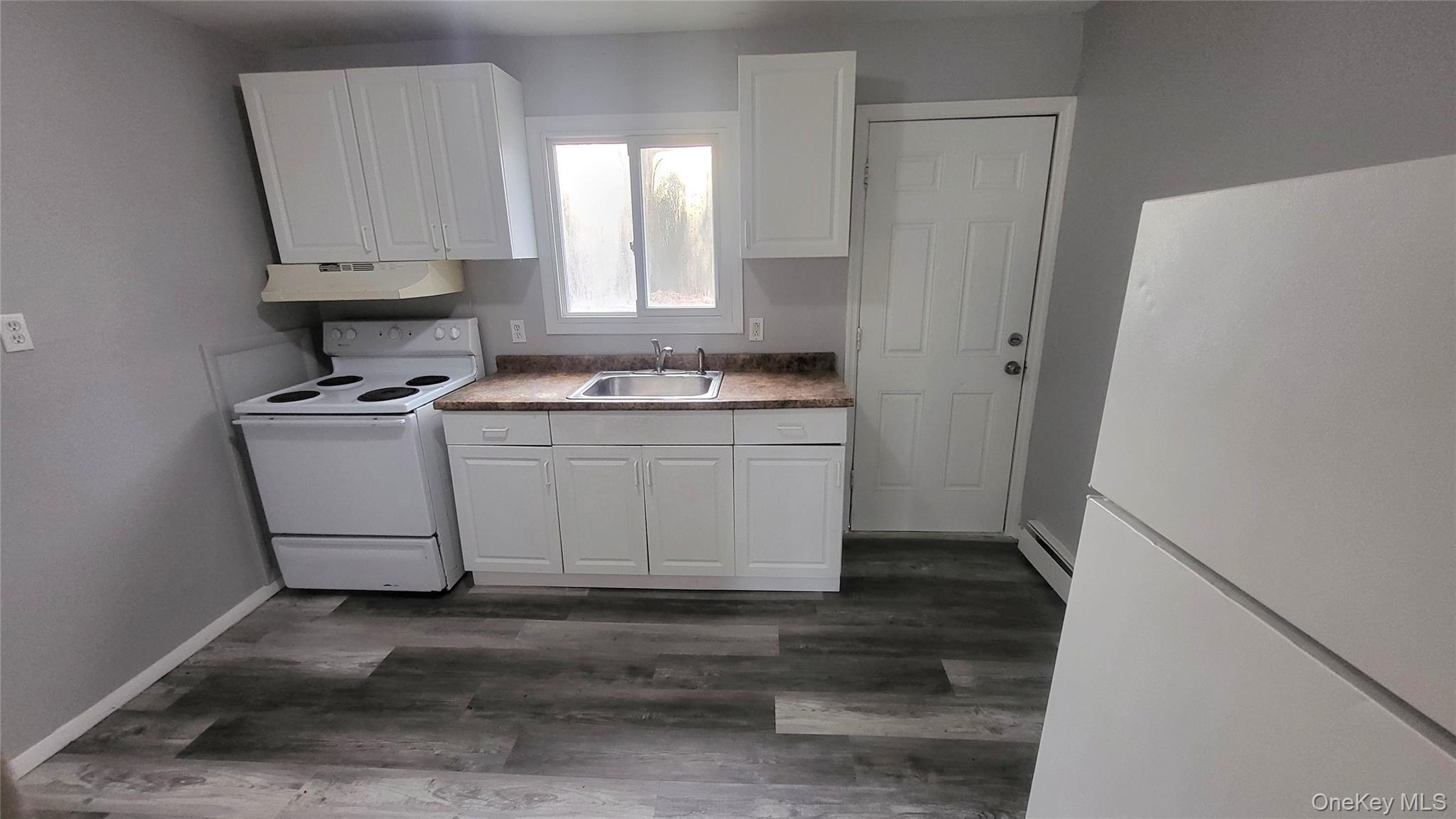 a kitchen with a stove a refrigerator and a sink