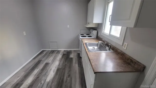 a view closeup a room with wooden floor and staircase