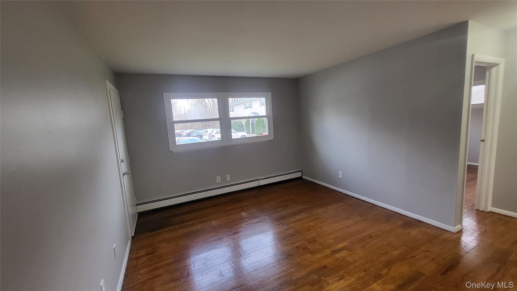 40 Haviland Road, Unit A7 Poughkeepsie, NY 12601 - Photo 6 of 12 an empty room with wooden floor and windows