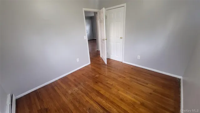 a view of room with wooden floor