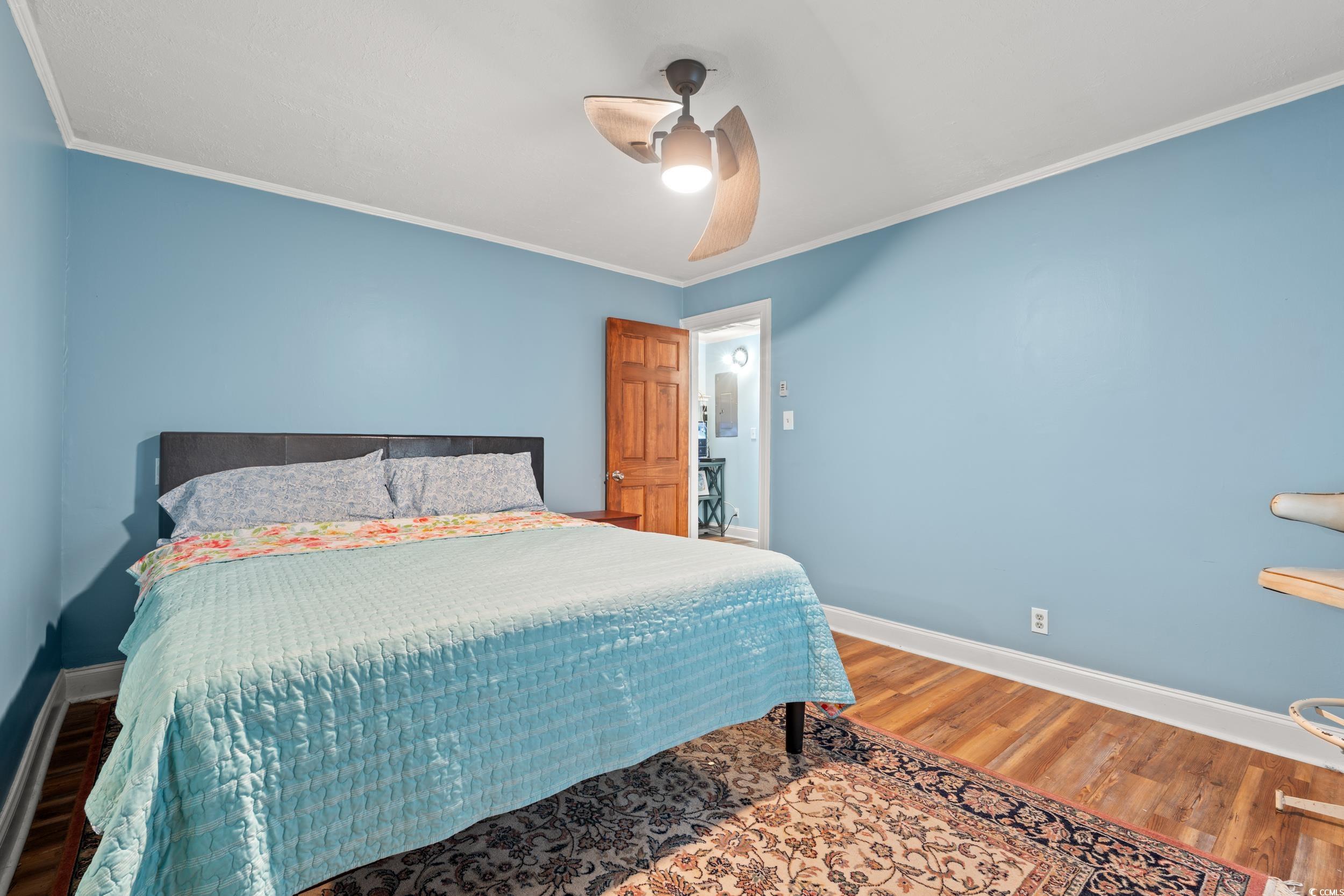 902 Palm Street Georgetown, SC 29440 - Photo 20 of 38 Bedroom featuring wood finished floors, ornamental molding, and ceiling fan