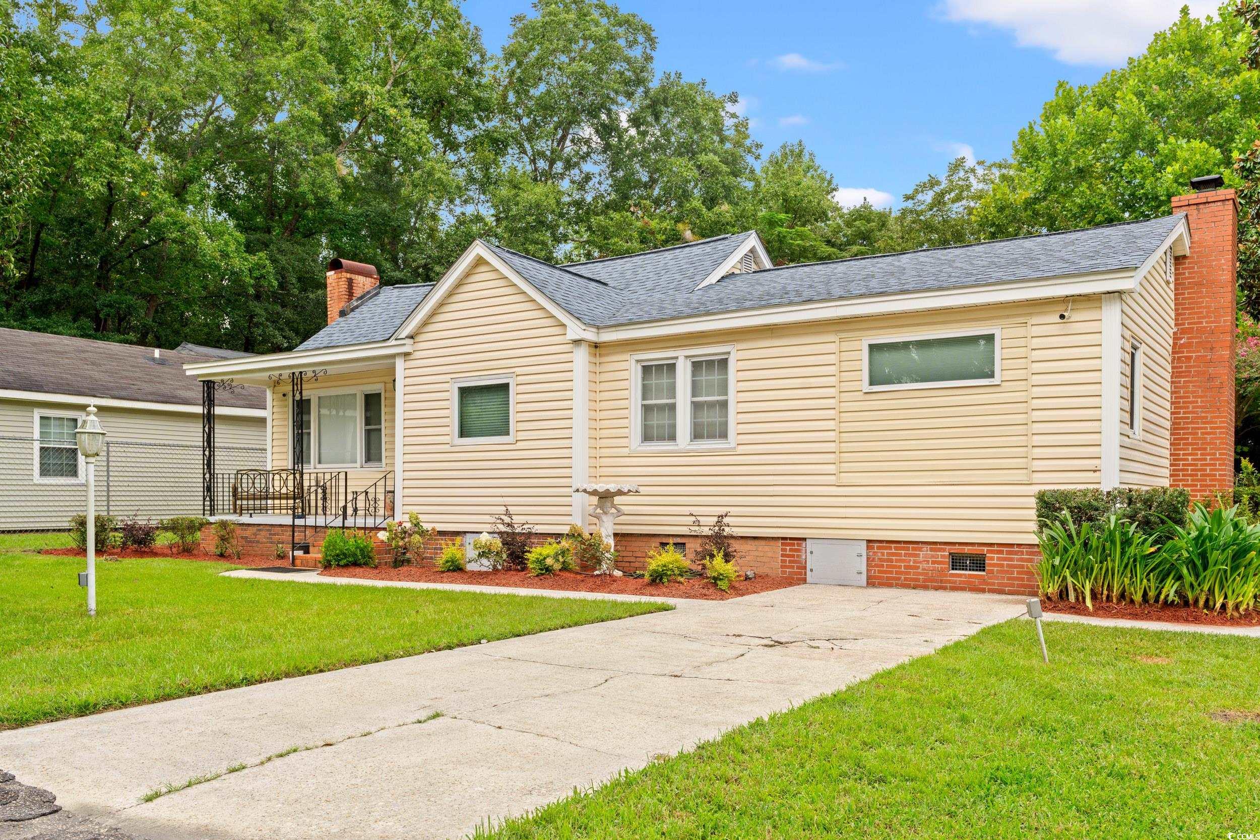 902 Palm Street Georgetown, SC 29440 - Photo 29 of 38 View of front facade featuring a porch, a chimney, a front yard, and crawl space