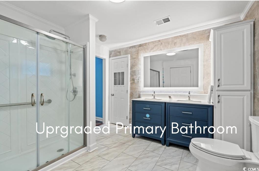 902 Palm Street Georgetown, SC 29440 - Photo 4 of 38 Full bath featuring a shower stall, light marble finish floors, ornamental molding, and double vanity