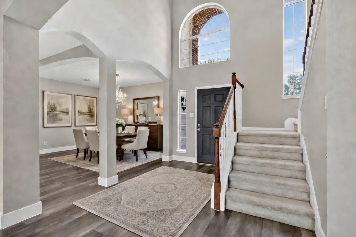 20926 Trellis Lane Houston, TX 77073 - Photo 2 of 22 Entry and dining area as you walk in, with laminate flooring throughout the downstairs (virtually staged).