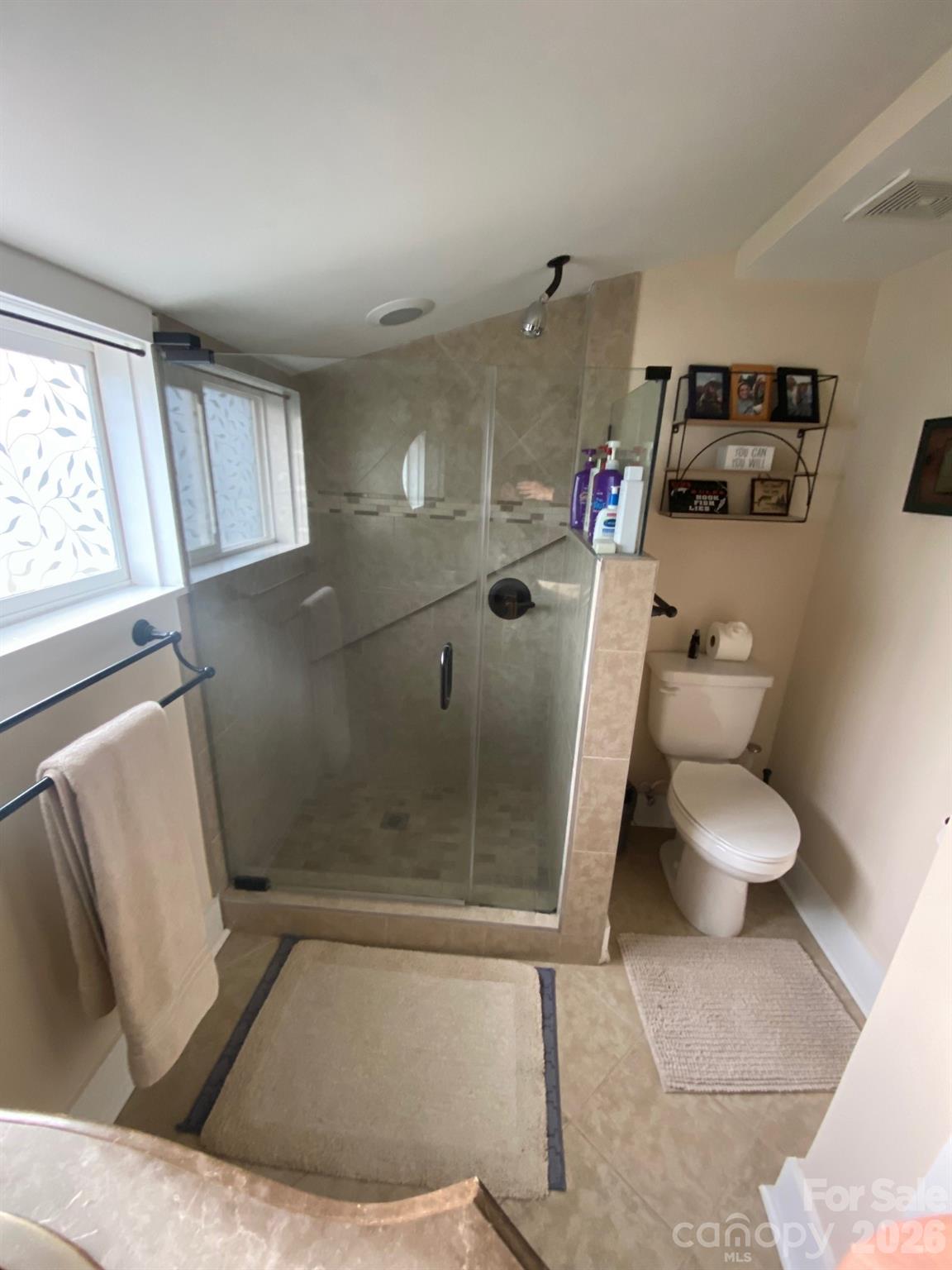 201 Main Street Matthews, NC 28105 - Photo 12 of 16 a bathroom with a toilet and a shower