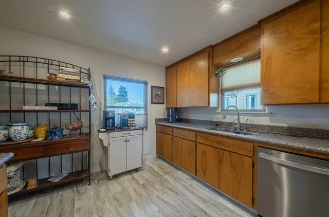 a kitchen with stainless steel appliances granite countertop a sink stove and cabinets