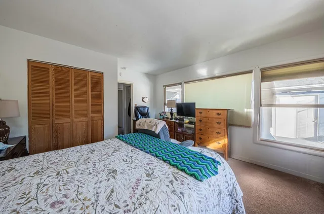 a bedroom with furniture and a window