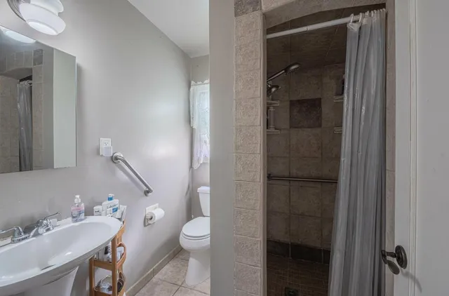 a bathroom with a toilet sink and shower