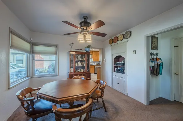 a living room with furniture a window and a chandelier