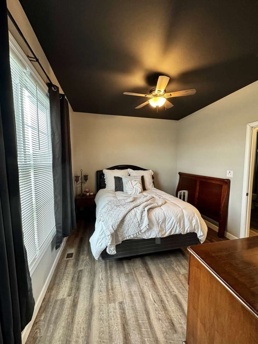 5056 Spencer Hale Road Morristown, TN 37813 - Photo 36 of 70 a bedroom with a bed and a chandelier