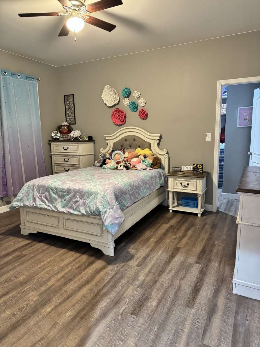5056 Spencer Hale Road Morristown, TN 37813 - Photo 51 of 69 a bedroom with a bed and a chandelier
