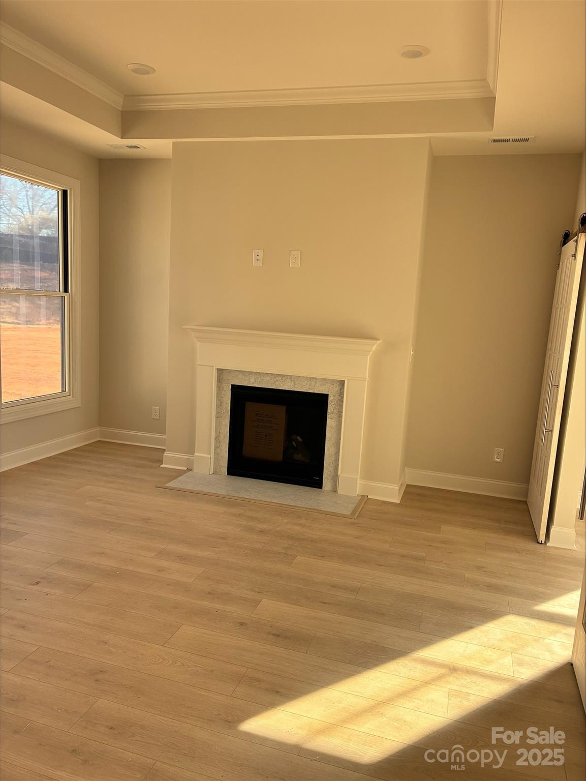 3027 Five Creek Road Charlotte, NC 28213 - Photo 12 of 17 a view of empty room with wooden floor and fireplace