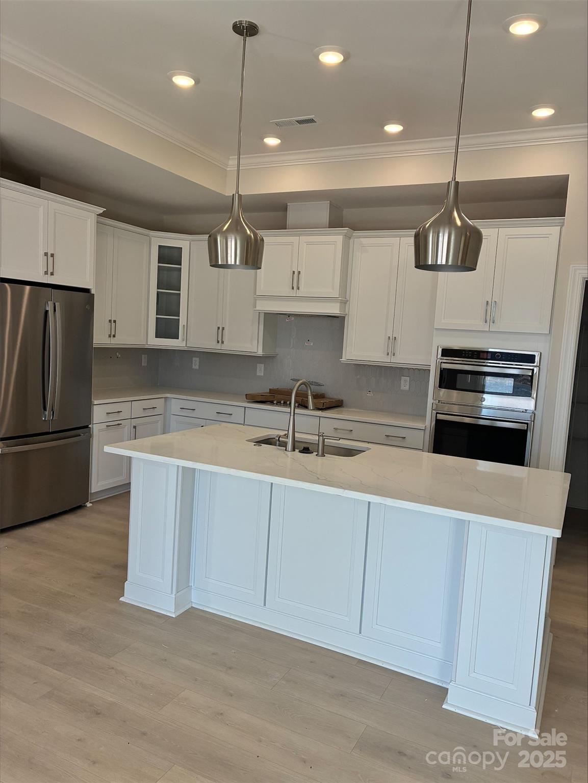 3027 Five Creek Road Charlotte, NC 28213 - Photo 4 of 17 a kitchen with kitchen island a sink stainless steel appliances and cabinets