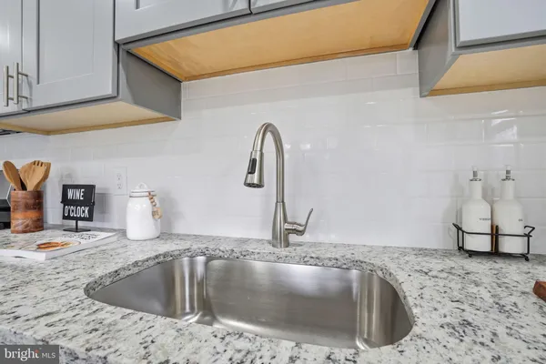 a kitchen with a sink and a stove top oven