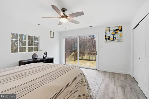 a bedroom with a large bed and a large window