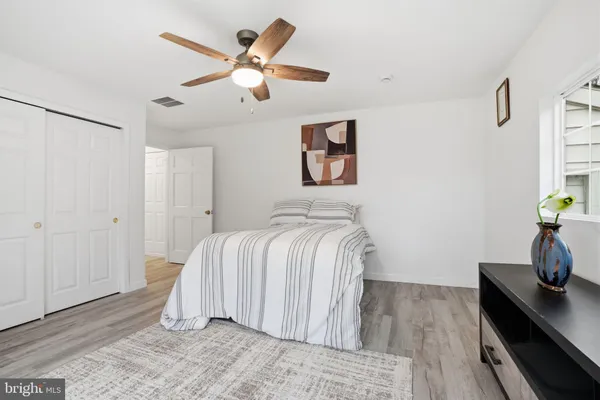 a bedroom with a bed and a desk