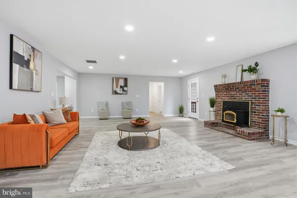 a living room with fireplace furniture and a fireplace