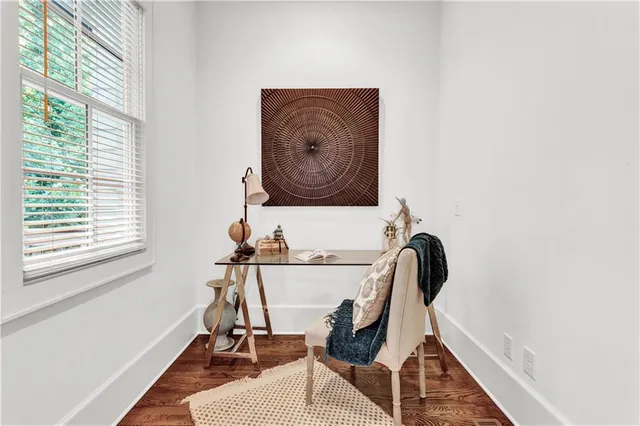 a living room with furniture a fireplace and a large window