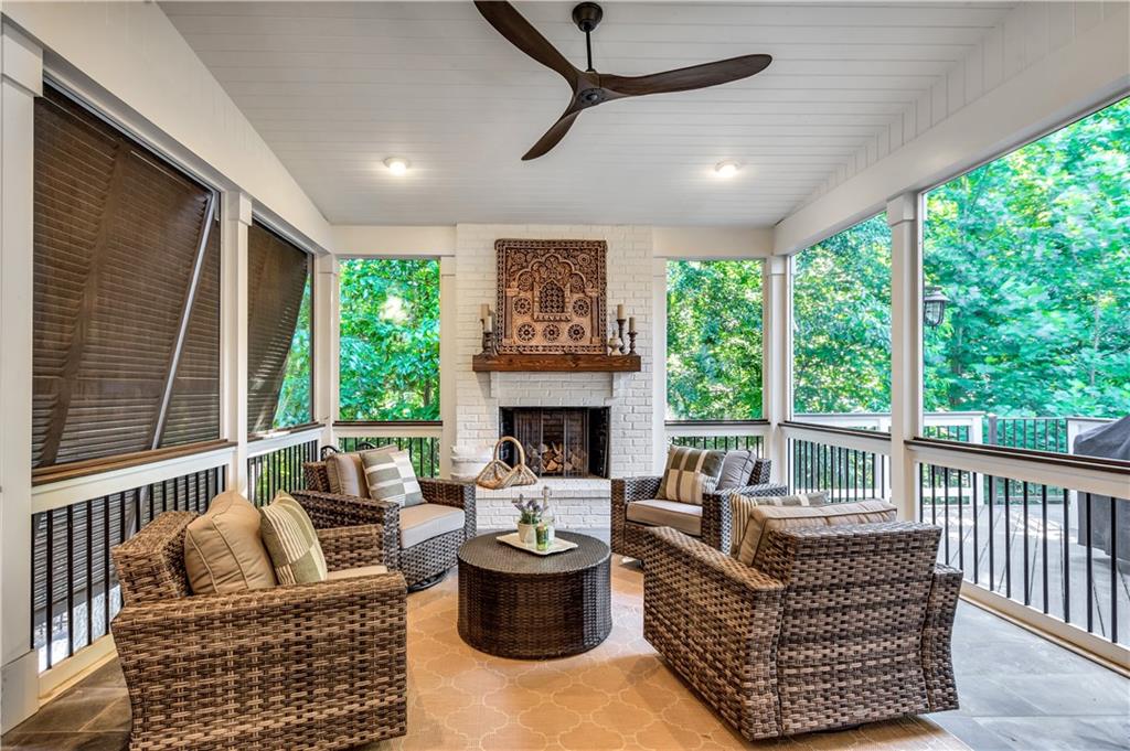 3081 Rhodenhaven Drive Northwest Atlanta, GA 30327 - Photo 12 of 57 a living room with furniture a fireplace and a large window