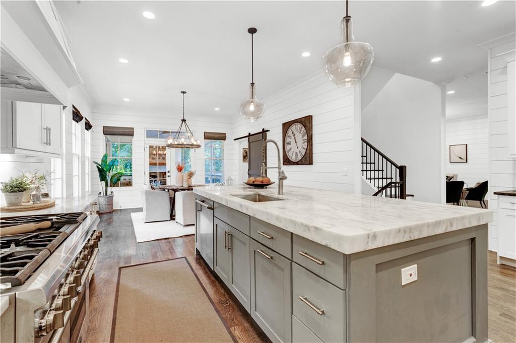 3081 Rhodenhaven Drive Northwest Atlanta, GA 30327 - Photo 15 of 57 a kitchen with kitchen island a counter top space a sink stainless steel appliances and cabinets