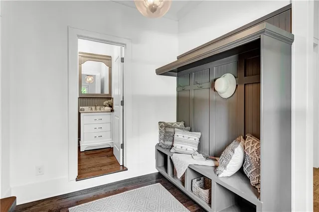 a bathroom with a toilet a sink and mirror