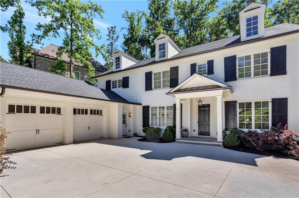 3081 Rhodenhaven Drive Northwest Atlanta, GA 30327 - Photo 2 of 57 a view of a white house with a yard