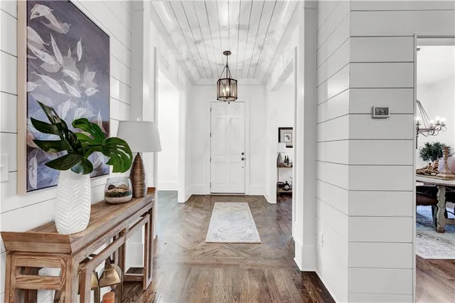 a dining room with furniture a rug and a large window