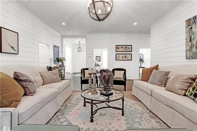 a spacious bedroom with a bed a couch and large window