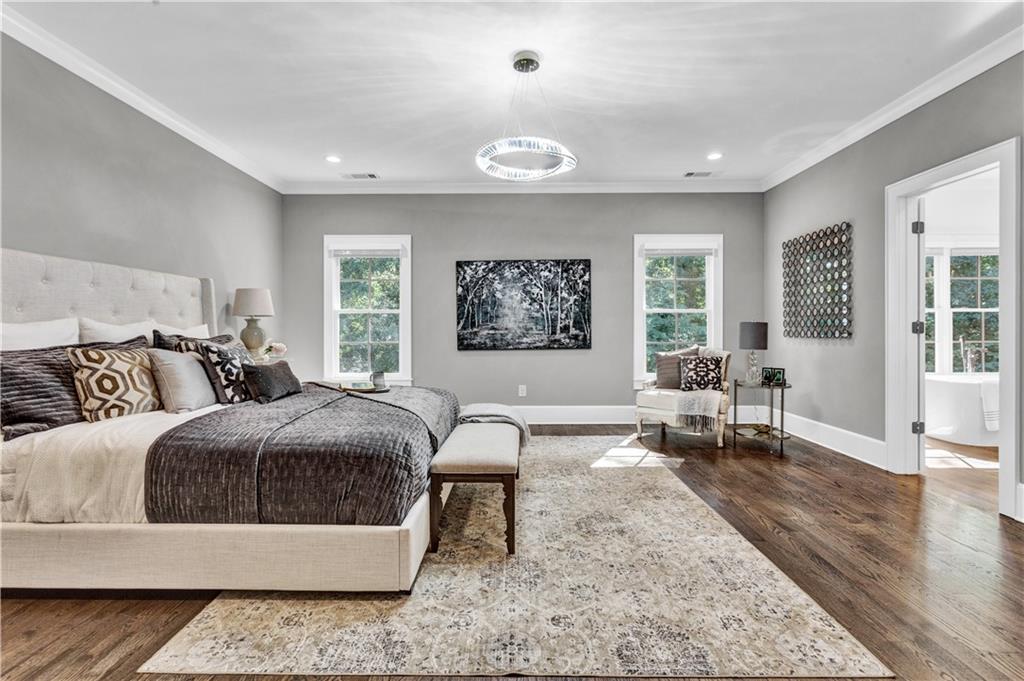 3081 Rhodenhaven Drive Northwest Atlanta, GA 30327 - Photo 32 of 57 a spacious bedroom with a bed a couch and large window