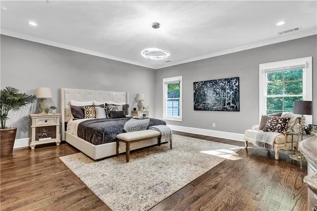 a bathroom with a double vanity sink a mirror and a bathtub