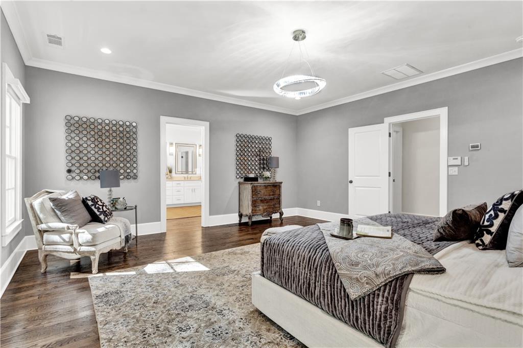 3081 Rhodenhaven Drive Northwest Atlanta, GA 30327 - Photo 34 of 57 a bedroom with a bed and wooden floor