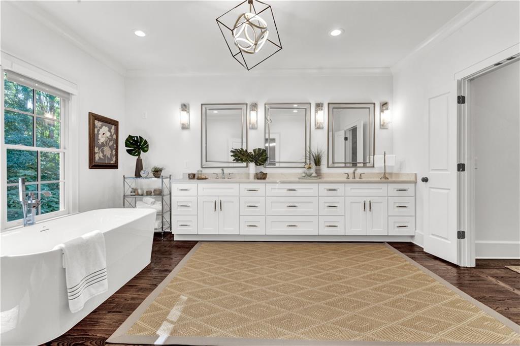 3081 Rhodenhaven Drive Northwest Atlanta, GA 30327 - Photo 35 of 57 a bathroom with a double vanity sink a mirror and a bathtub
