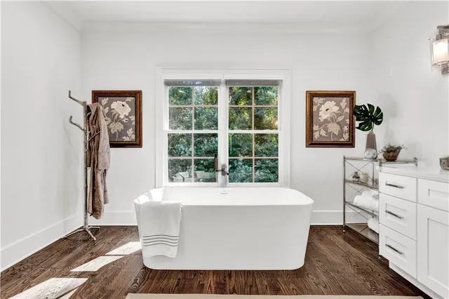a spacious bedroom with a bed and a chandelier