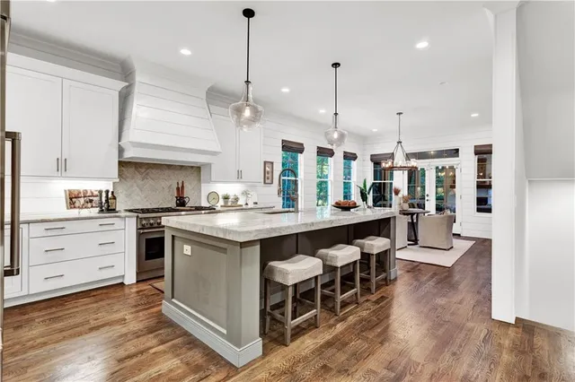 a large kitchen with a table and chairs