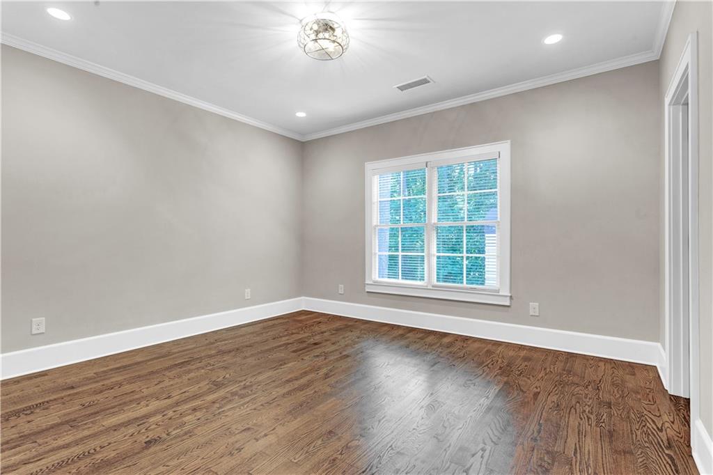 3081 Rhodenhaven Drive Northwest Atlanta, GA 30327 - Photo 43 of 57 a view of an empty room with wooden floor and a window