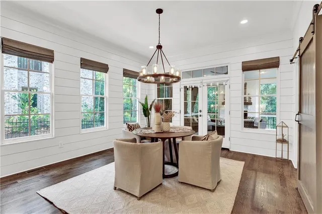 a kitchen with stainless steel appliances granite countertop a sink a stove and a wooden floors
