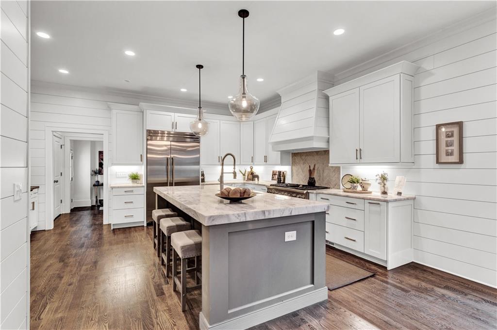 3081 Rhodenhaven Drive Northwest Atlanta, GA 30327 - Photo 8 of 57 a kitchen with stainless steel appliances granite countertop a sink a stove and a wooden floors