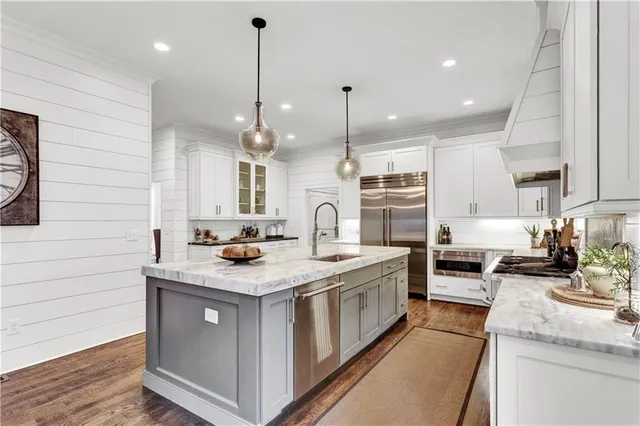 a living room with furniture a chandelier and a table