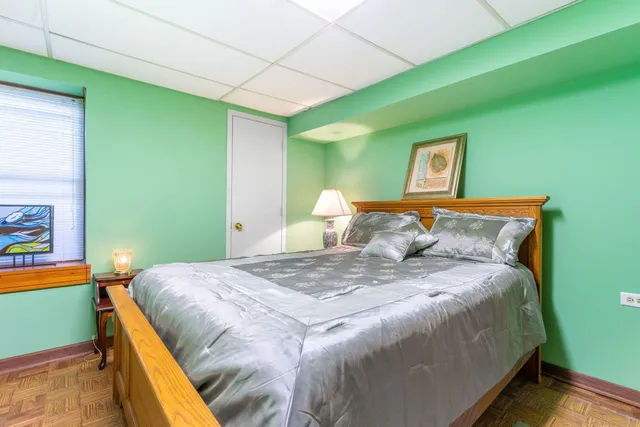 a bed sitting in a bedroom next to a window