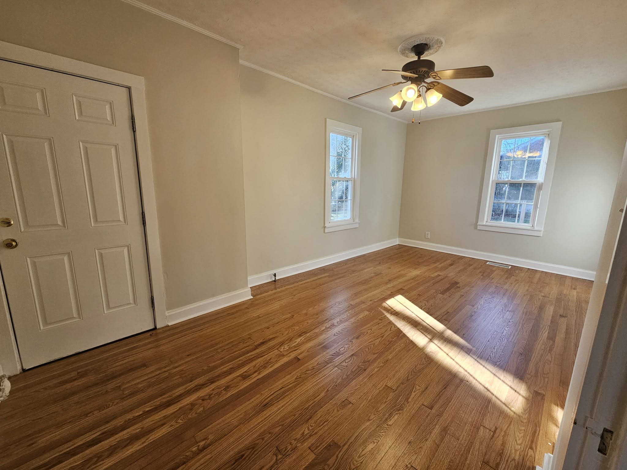 205 Fite Avenue West Carthage, TN 37030 - Photo 31 of 55 an empty room with wooden floor chandelier fan and windows