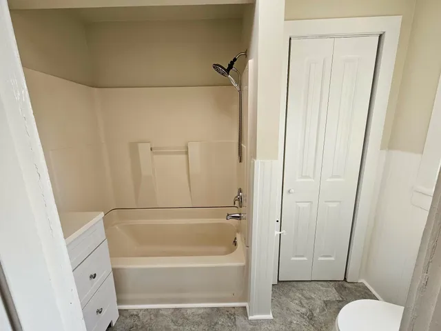a kitchen with a sink a wooden floor and a large window