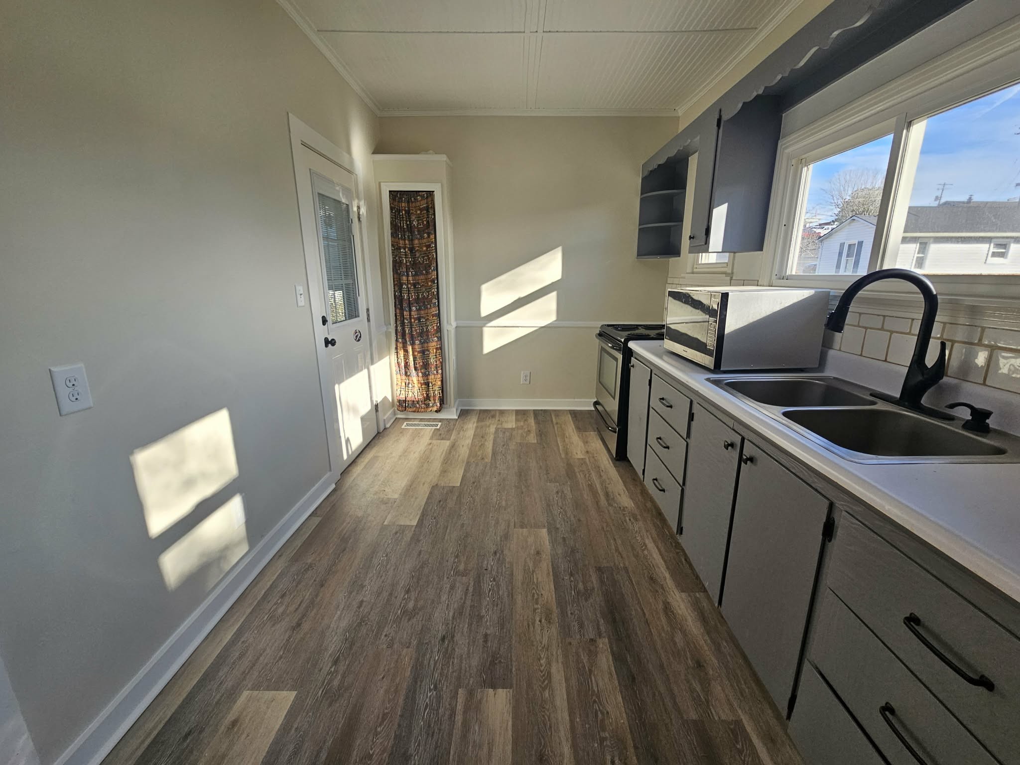 205 Fite Avenue West Carthage, TN 37030 - Photo 39 of 55 a kitchen with a sink a wooden floor and a large window