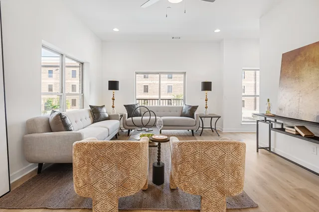 a living room with fireplace furniture and wooden floor