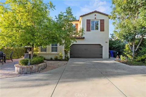a front view of a house with a yard and a garage